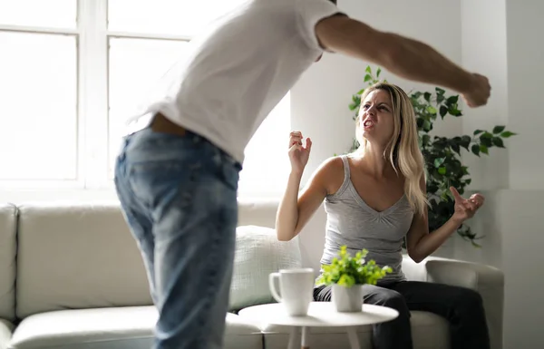 Man beating up his wife illustrating domestic violence — Stock Photo, Image