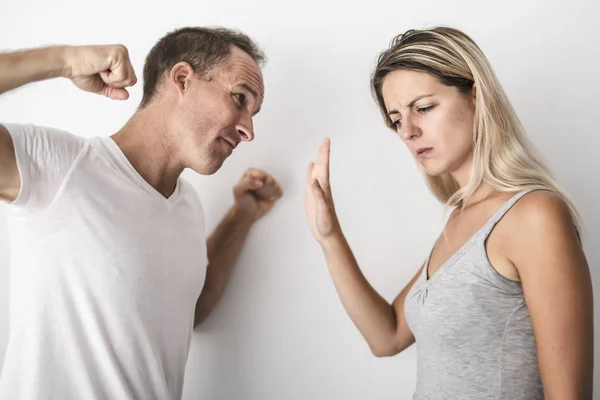 Man beating helpless woman at home white background — Stock Photo, Image
