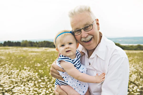 Grandfather spending time with little child during the sunset. — Stock Photo, Image