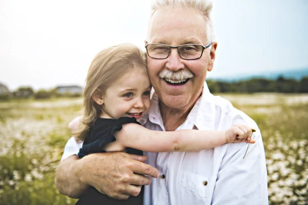 Grandfather spending time with little child during the sunset. — Stock Photo, Image