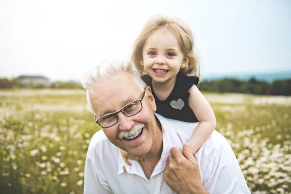 Grandfather spending time with little child during the sunset. — Stock Photo, Image