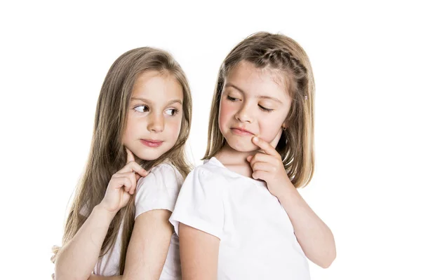 Portrait of two cute friends 7 years old girl Isolated over white background pensive — Stock Photo, Image