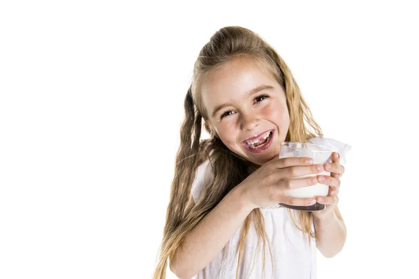 Portrett av en søt 7 år gammel jente isolert over hvit bakgrunn med melkeglass – stockfoto