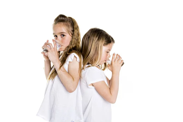 Portrait of a cute 7 years old girl Isolated over white background with milk glass — Stock Photo, Image