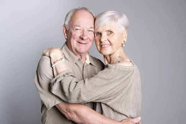 Senior couple posing on studio gray background — Stock Photo, Image