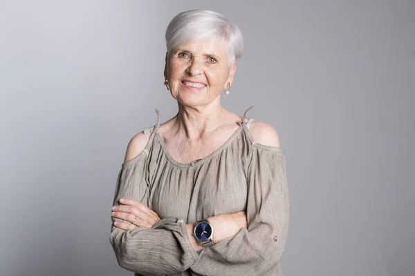 Elderly woman on studio dark gray background — Stock Photo, Image