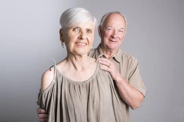 Senior couple posing on studio gray background — Stock Photo, Image