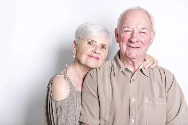 Senior couple posing on studio white background — Stock Photo, Image