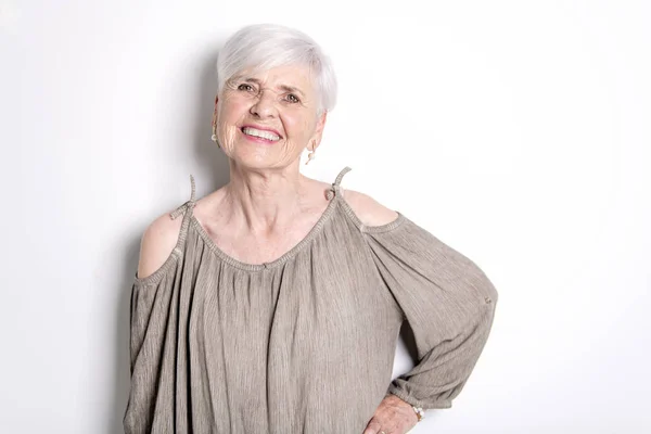 Elderly woman on studio white background — Stock Photo, Image