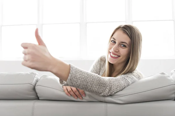 Young woman on a sofa on the living room — Stock Photo, Image