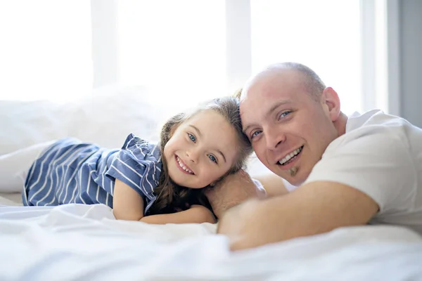 Šťastný otec a dcera baví spolu na posteli — Stock fotografie