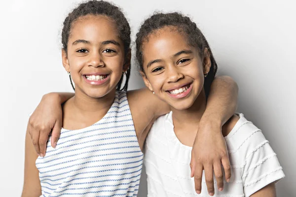 Adorable african twin little girls on studio gray background — Stock Photo, Image