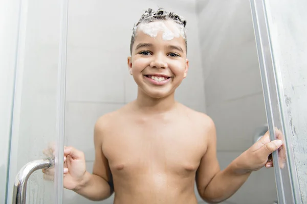 A nice Boy on the shower having fun — Stockfoto