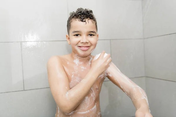 A nice Boy on the shower having fun — Stockfoto