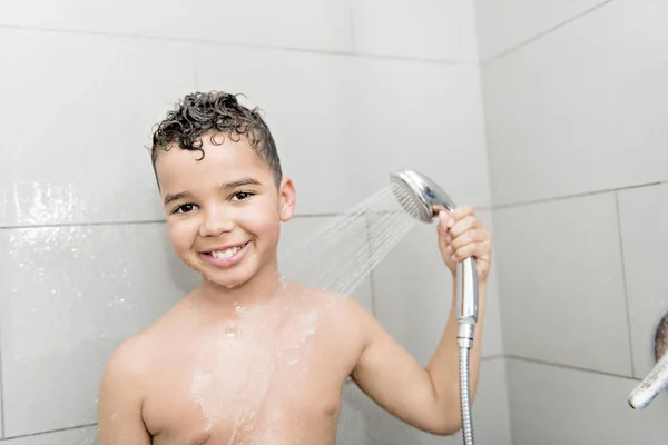 A nice Boy on the shower having fun — Stockfoto