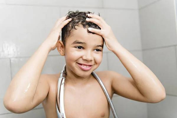 A nice Boy on the shower having fun — Stockfoto
