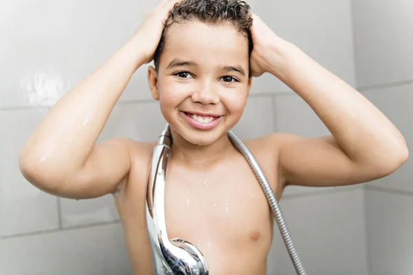 A nice Boy on the shower having fun — Stockfoto