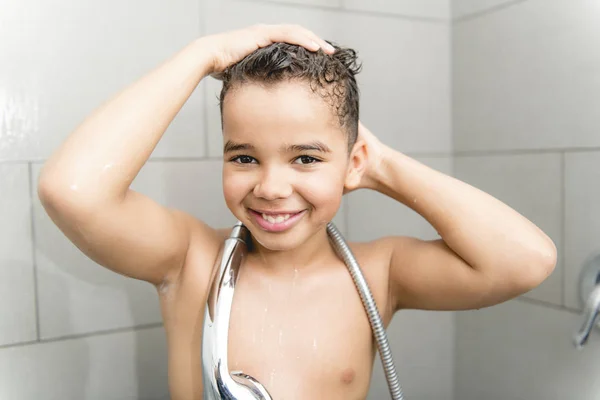 A nice Boy on the shower having fun — Stockfoto