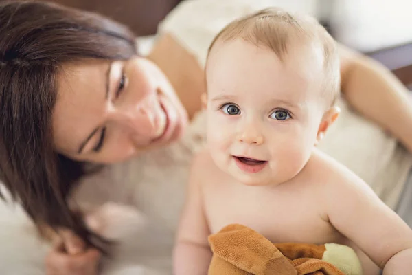 Madre jugando con su bebé en el dormitorio — Foto de Stock