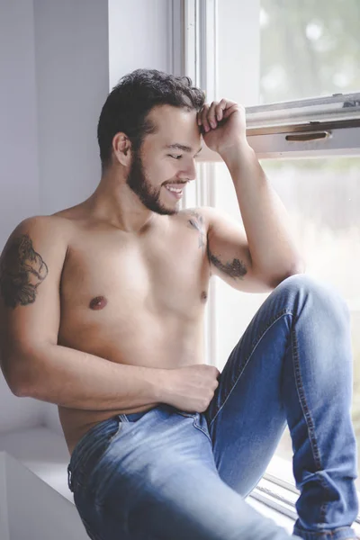 Sexy fashion portrait of a hot male model in stylish jeans with muscular body — Stock Photo, Image