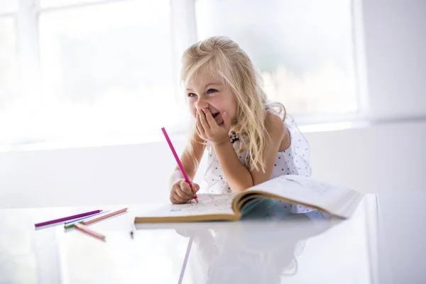 Little girl drawing in the kitchen table — Stock Photo, Image