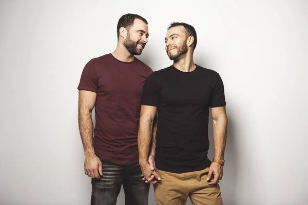 Young homosexuals gay couple love each other on a white background. — Stock Photo, Image