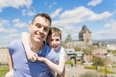 Father And Son on his shoulder In summer season clipart