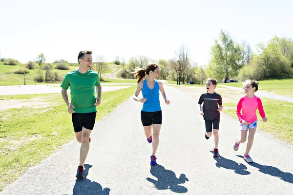 Parents with children sport running together outside — Stock Photo, Image