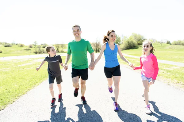 Parents with children sport running together outside