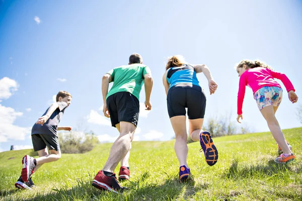 Parents with children sport running together outside — Stock Photo, Image