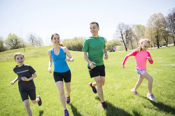 Parents with children sport running together outside — Stock Photo, Image