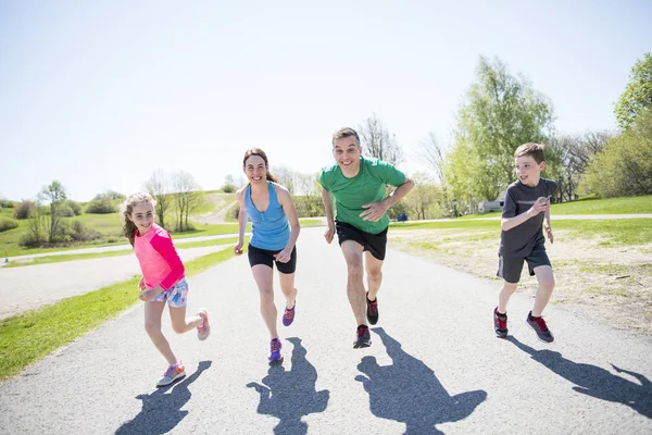 Parents with children sport running together outside