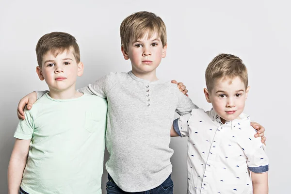 Three friends brother together on studio white background — Stock Photo, Image