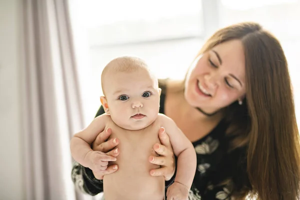 A Portrait of happy baby with cheerful mother at home bedroom — Stock Photo, Image