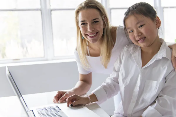 Skolflicka forska på nätet med vägledning av sin lärare — Stockfoto