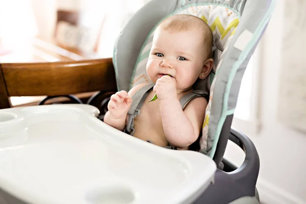 Baby girl sitting in high chair ready for eating — Stock Photo, Image