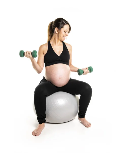 Спортивная беременная женщина с гантелями. — стоковое фото