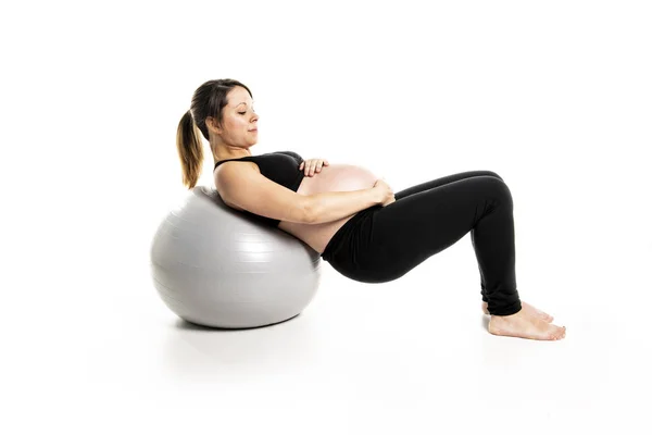 A Sporty pregnant woman exercising with ball — Stock Photo, Image