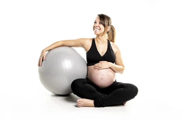 A Sporty pregnant woman exercising with ball — Stock Photo, Image