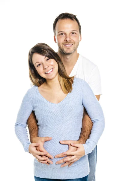 Eine schwangere Frau mit Mann im Studio isoliert auf weiß — Stockfoto