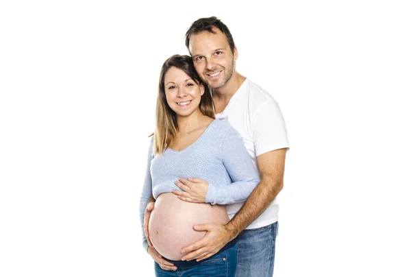 Eine schwangere Frau mit Mann im Studio isoliert auf weiß — Stockfoto