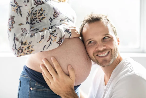 A Handsome man and beautiful pregnant wifes tummy — Stock Photo, Image
