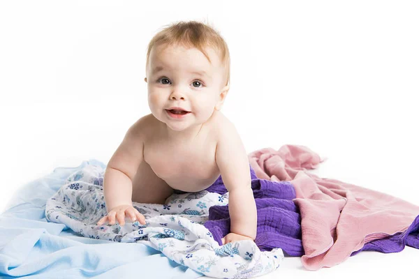 Bébé marche sous une serviette. Age de 10 mois. Il est isolé sur un fond blanc — Photo