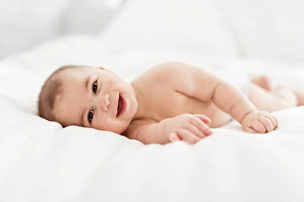 Portrait of a baby boy on the bed in bedroom — Stock Photo, Image