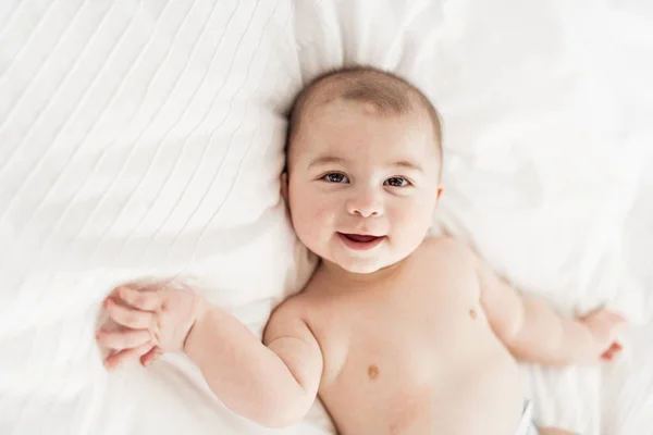 Portrait of a baby boy on the bed in bedroom — Stock Photo, Image