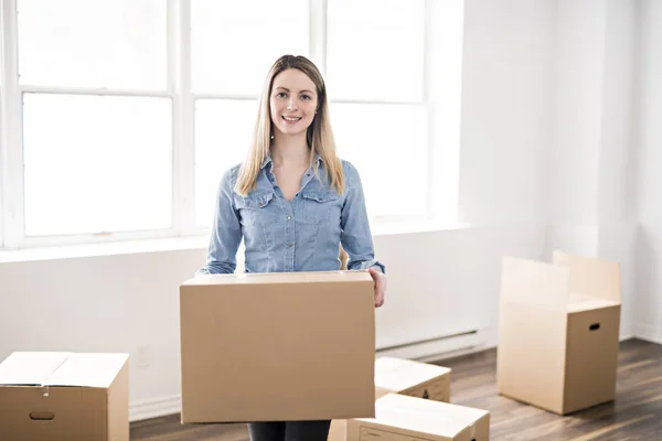 A beautiful woman with box at home — Stock Photo, Image