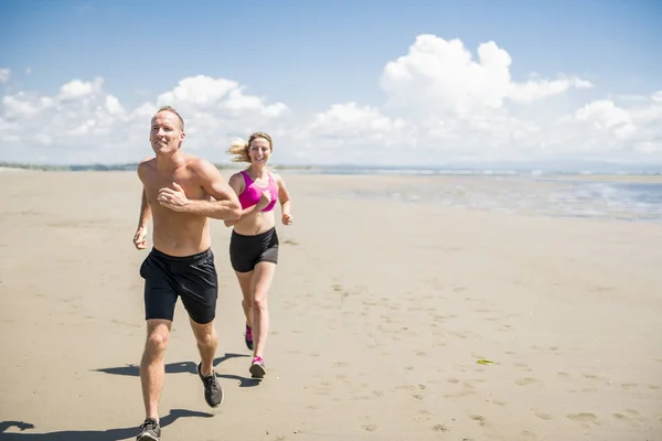 Fitness running couple exercising cardio on beach. — Stock Photo, Image