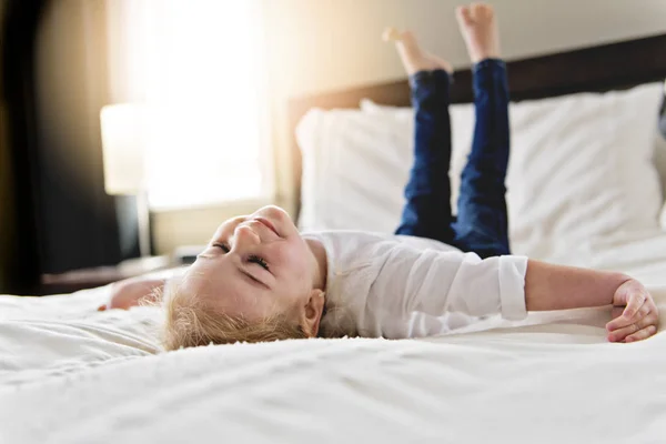 Kleine Tochter zwei Jahre alt entspannt im Bett, positive Gefühle — Stockfoto