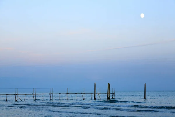 Beach landscape at dawn with moon. Jesolo beach view, Italian panorama