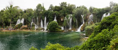 Panorama of beautiful Kravica waterfall in Bosnia and Herzegovina - popular swimming and picnic area for tourists clipart